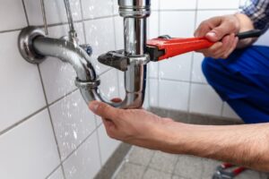 Plumber Fixing a Kitchen Drain