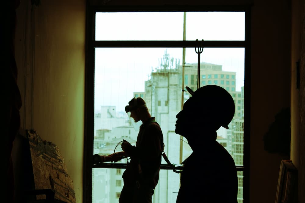 The Shadows of Two Men While Working
