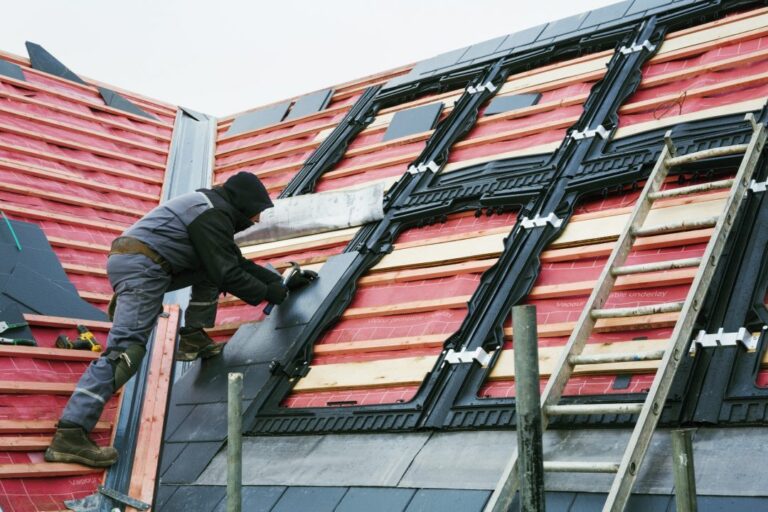 a roofer replacing the tiles on a house roof  768x512